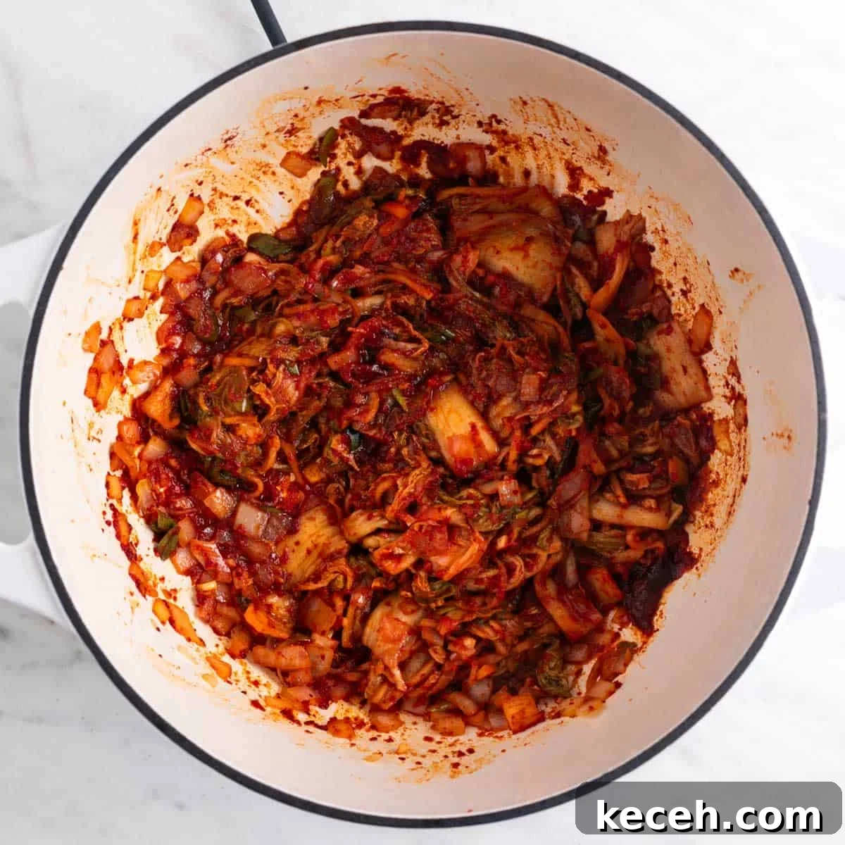 Vegan Kimchi Jjigae Recipe — Spicy Korean Kimchi Stew 5 Sautéed onion, garlic, kimchi, and seasonings in a large pot.