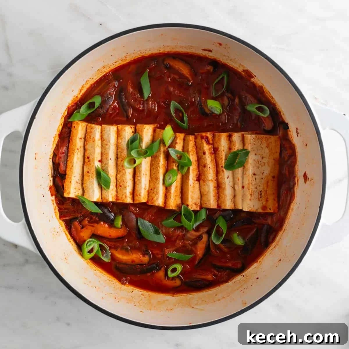 Vegan Kimchi Jjigae Recipe — Spicy Korean Kimchi Stew 9 Vegan kimchi stew in a large pot with scallions on top.