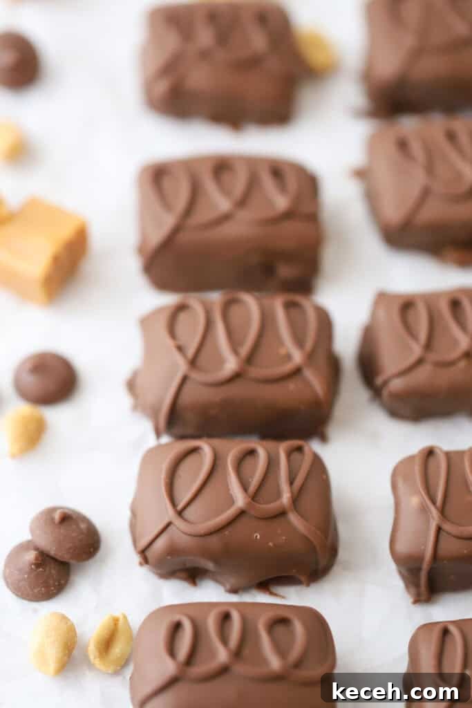 Snickers Candy: Flavor, Nutrition, and Serving Ideas 6 Chocolate covered candy bars with drizzled chocolate over the top.