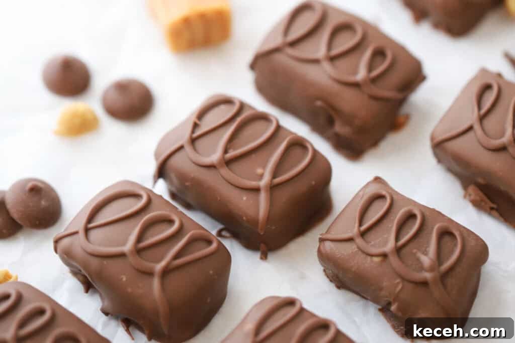 Snickers Candy: Flavor, Nutrition, and Serving Ideas 7 Homemade snickers candy bars on a baking sheet covered with parchment paper.