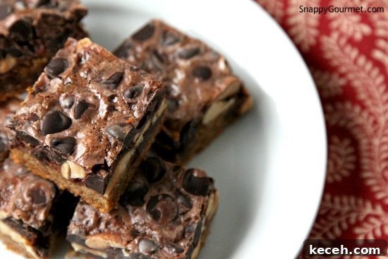 CHOCOLATE PEANUT BUTTER MAGIC BARS Chocolate Peanut Butter Magic Bars stacked on plate