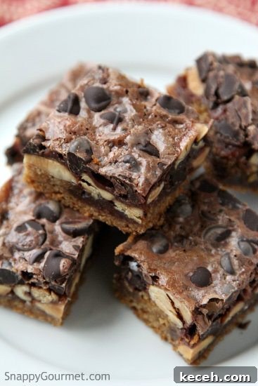 CHOCOLATE PEANUT BUTTER MAGIC BARS Chocolate Peanut Butter Magic Bars stacked on plate
