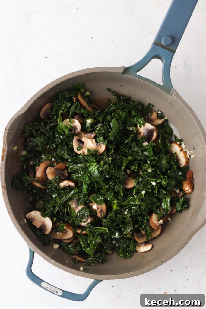 kale and mushrooms in a pan