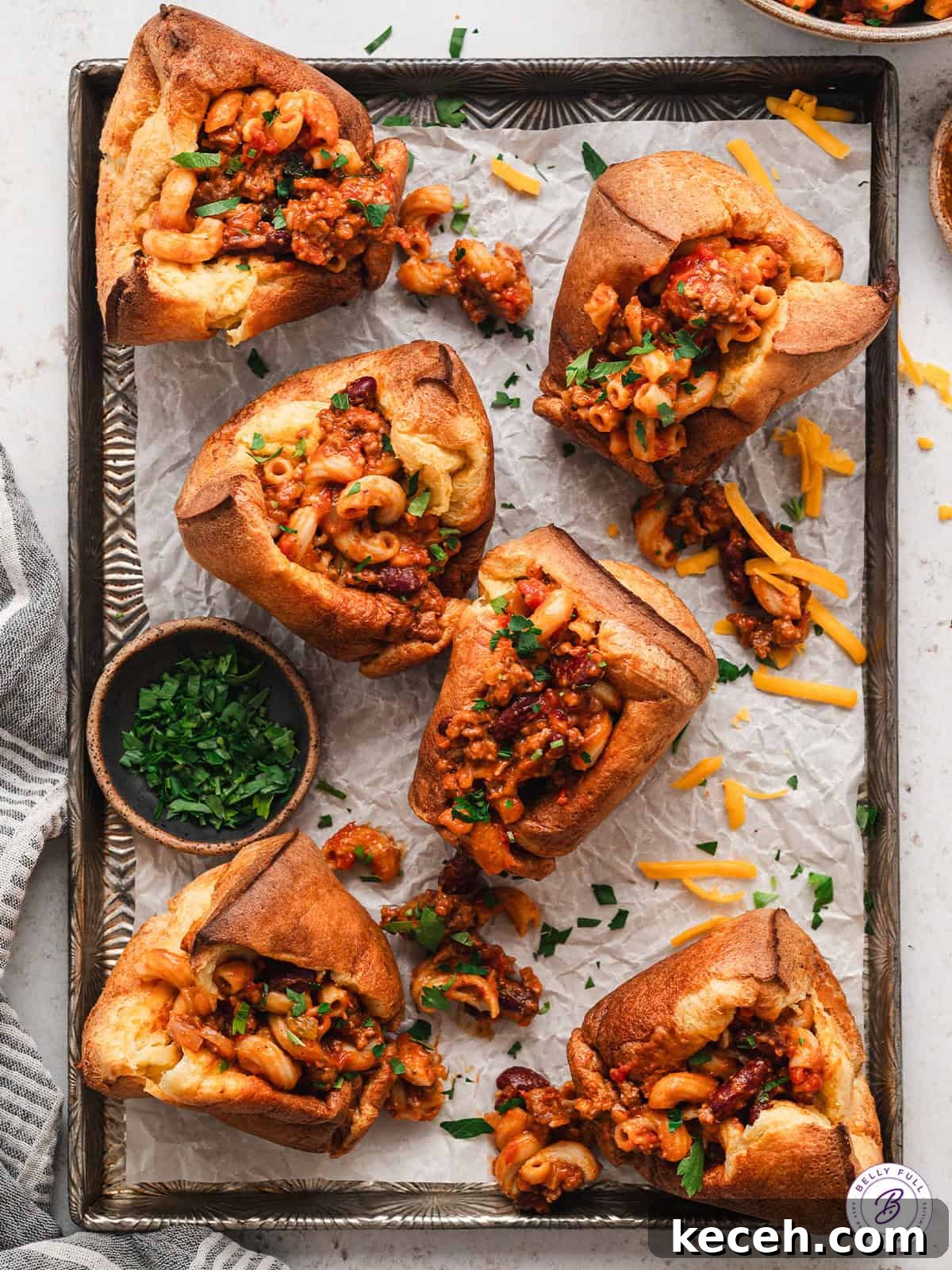 Overhead view of chili mac popovers on a baking sheet