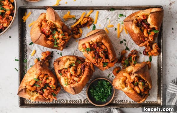 Overhead view of a baking sheet of chili mac stuffed popovers