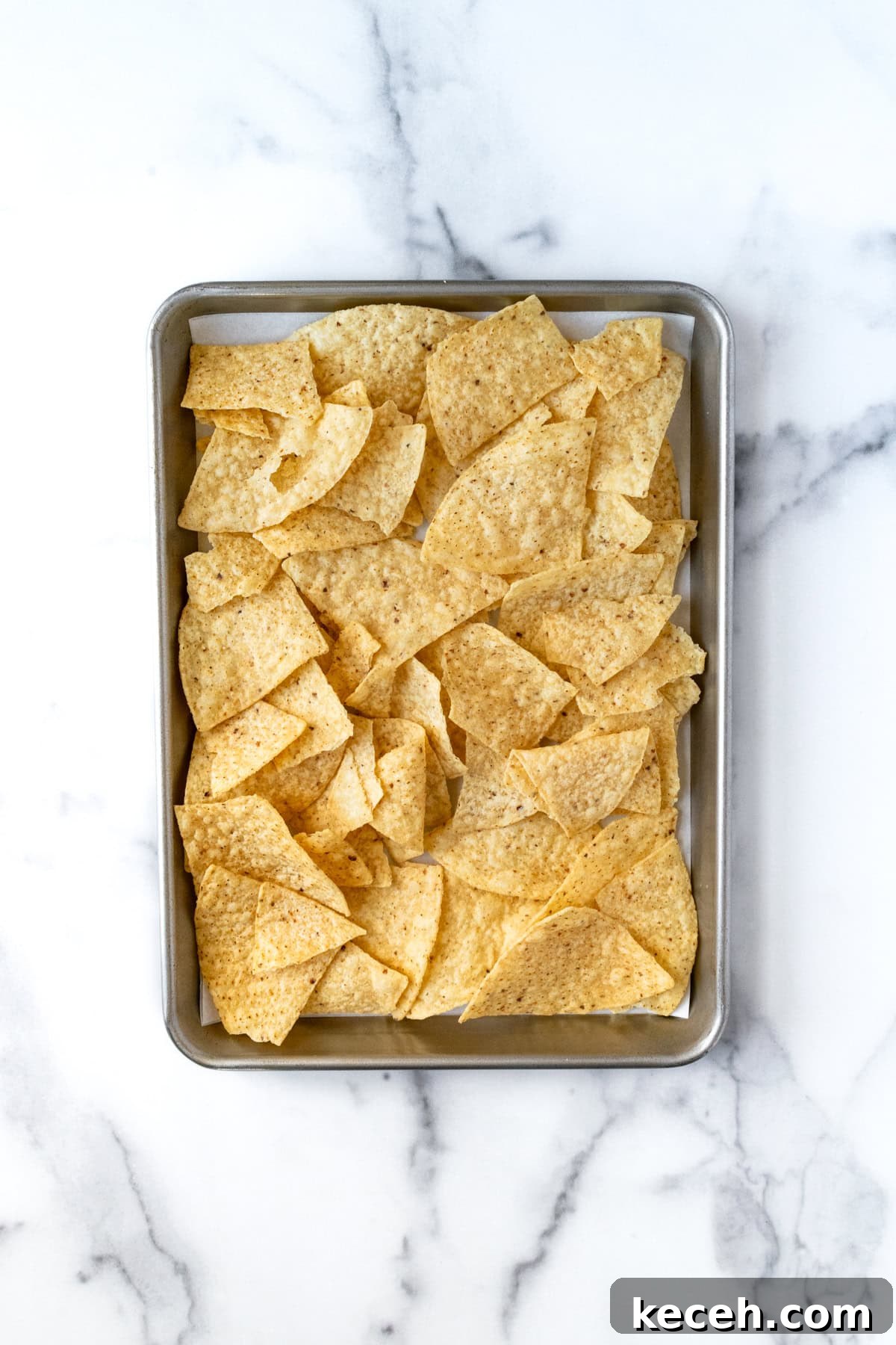 Loaded Black Bean Nachos with Fresh Salsa and Melted Cheese 4 Tortilla Chips on a Baking Sheet.