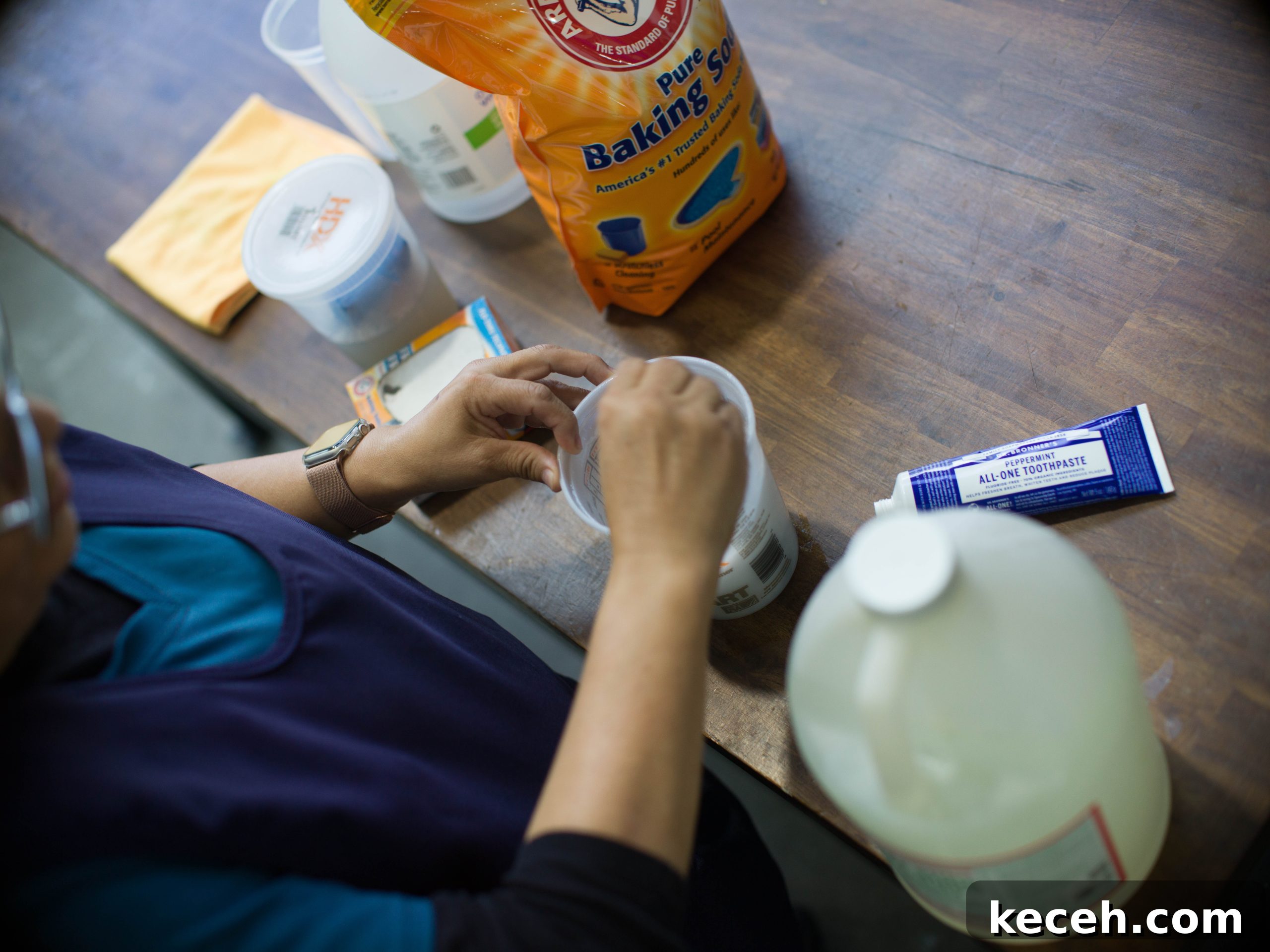 Dr. Bronner’s Guide to Commercial Facility Cleaning and Disinfection 4 Azucena stirring a mixture of baking soda, Dr. Bronner's toothpaste, and Dr. Bronner's Sal Suds.