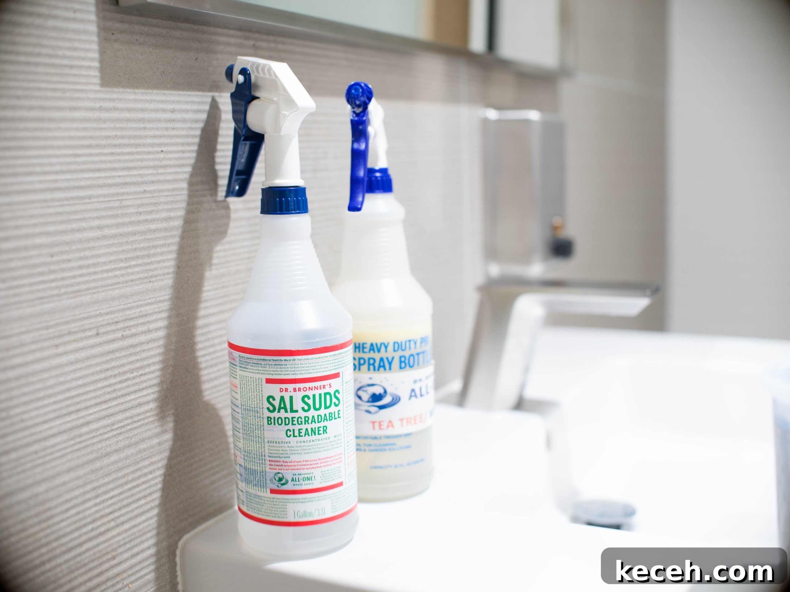 Dr. Bronner’s Guide to Commercial Facility Cleaning and Disinfection 5 Two spray bottles sitting on top of a sink counter.