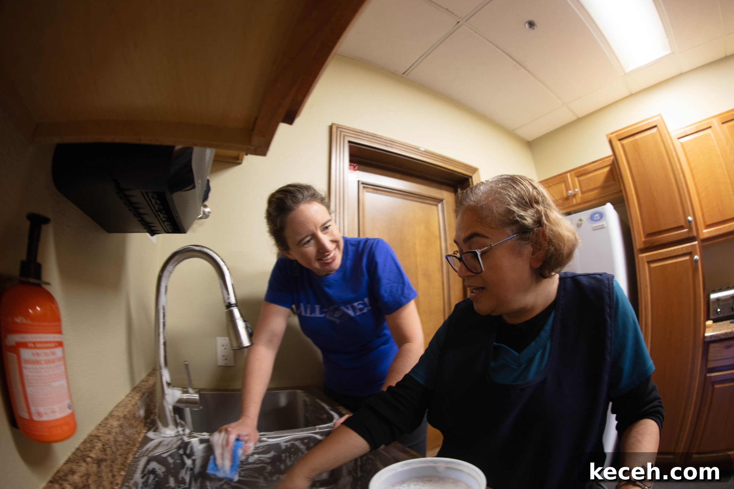 Dr. Bronner’s Guide to Commercial Facility Cleaning and Disinfection 7 Lisa Bronner and Azucena laughing and talking while cleaning a sink in the breakroom.