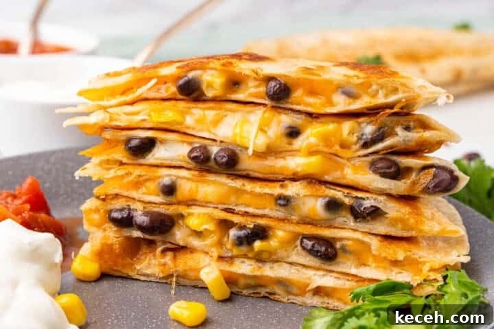 Fresh Summer Dinner Ideas: Light, Flavorful Recipes for Warm Nights 18 Black Bean Quesadillas stacked on a grey plate.