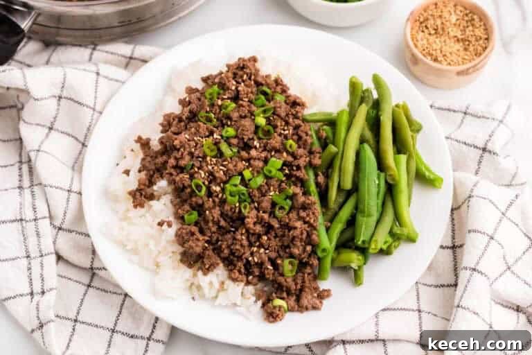 Fresh Summer Dinner Ideas: Light, Flavorful Recipes for Warm Nights 23 Asian Ground Beef served on a bed of rice with green beans.