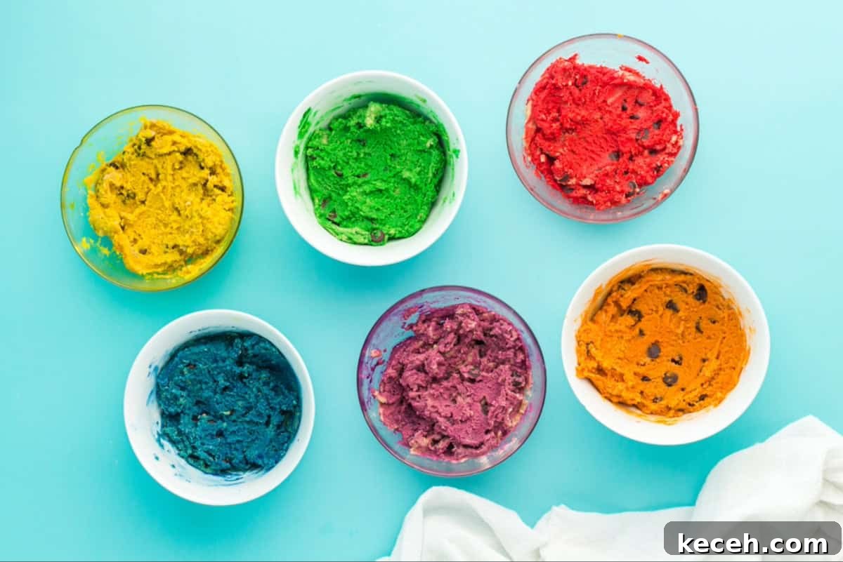 Bowls of chocolate chip cookie dough dyed a range of rainbow colors.