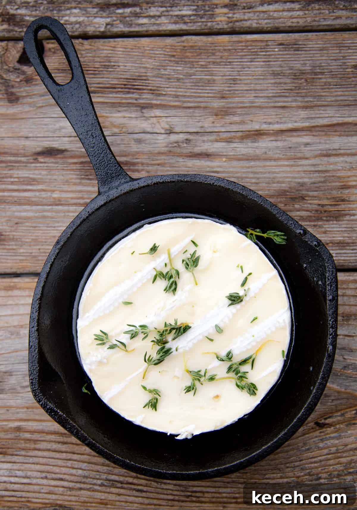 Grilled Baked Brie with Wine-Infused Glaze 3 Brie cheese in a cast iron pan