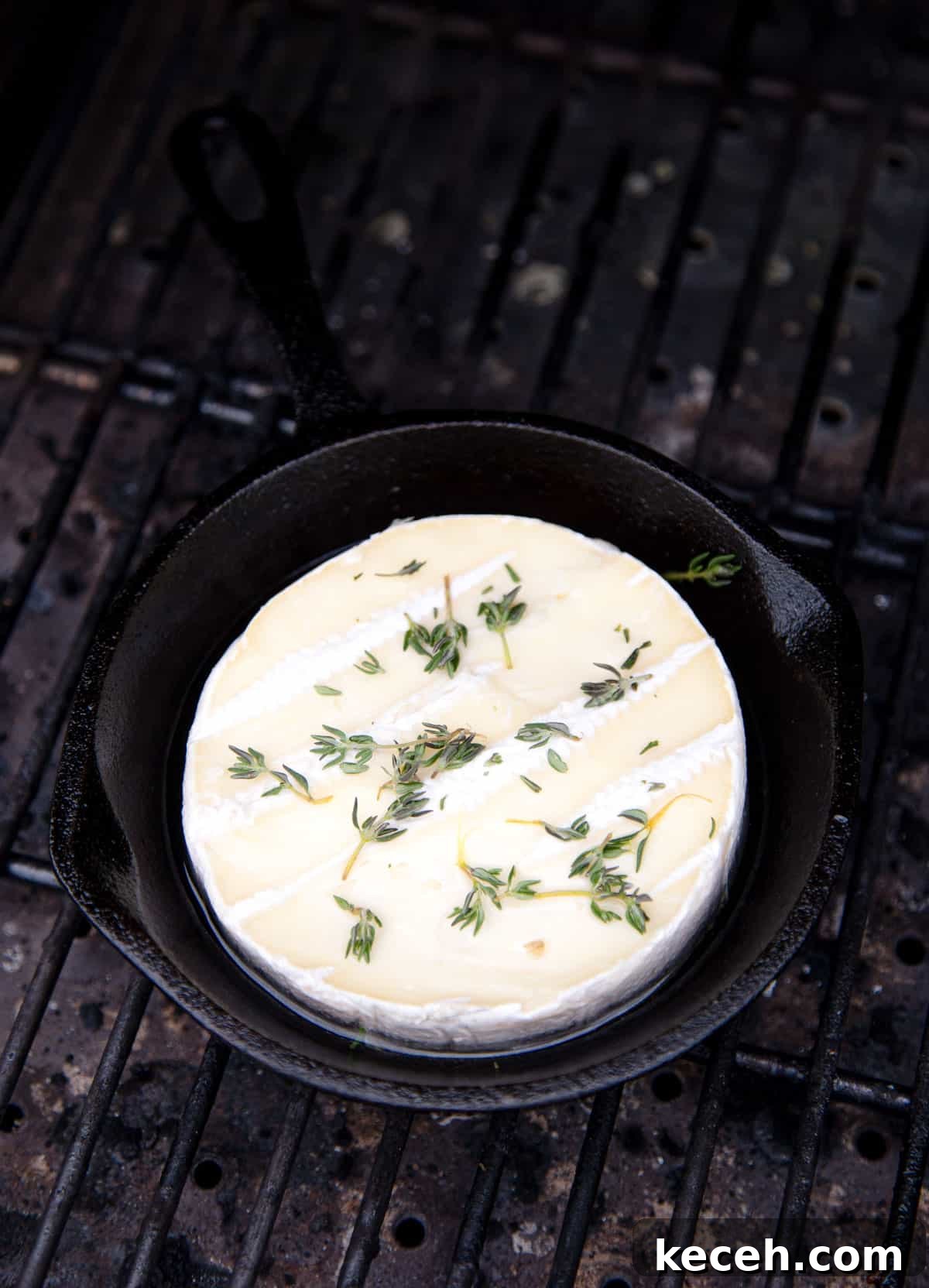 Grilled Baked Brie with Wine-Infused Glaze 4 Brie cheese in a cast iron pan on the grill