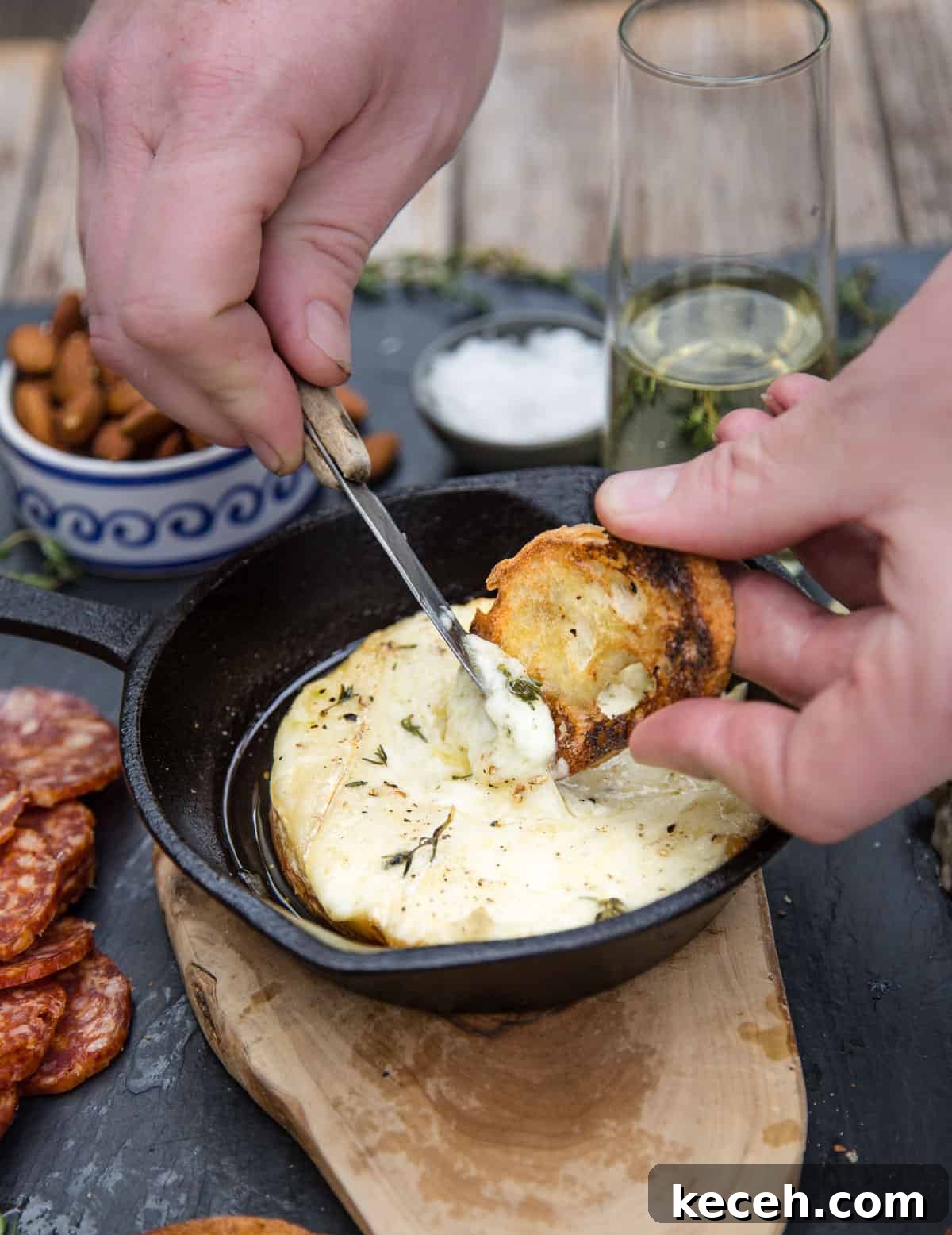 Grilled Baked Brie with Wine-Infused Glaze 5 Spreading creamy cheese on a toasted baguette slice