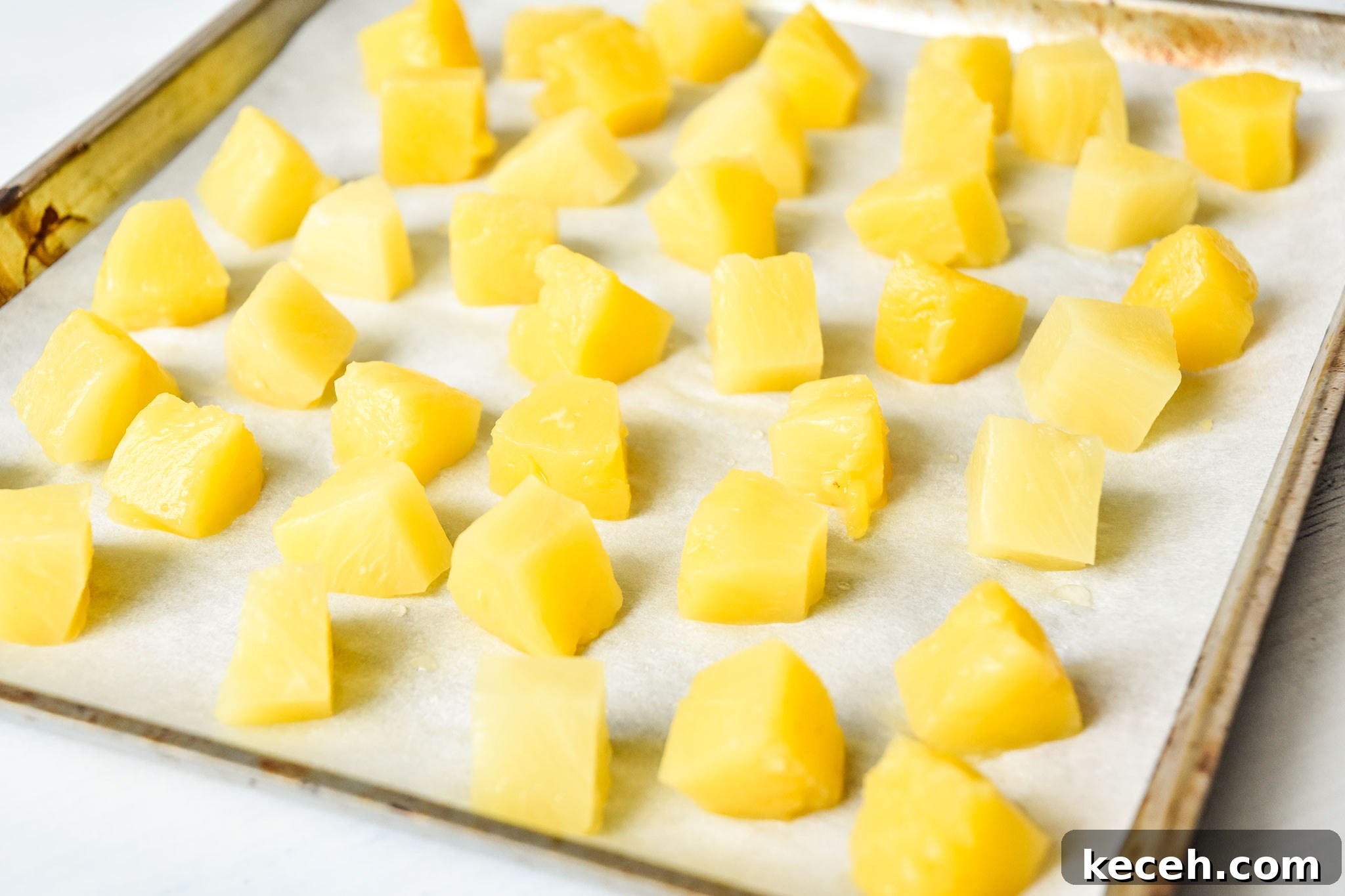 Refreshing White Wine Sangria Recipe for Summer Gatherings 4 sheet pan of pineapple chunks to be frozen for summer white wine sangria