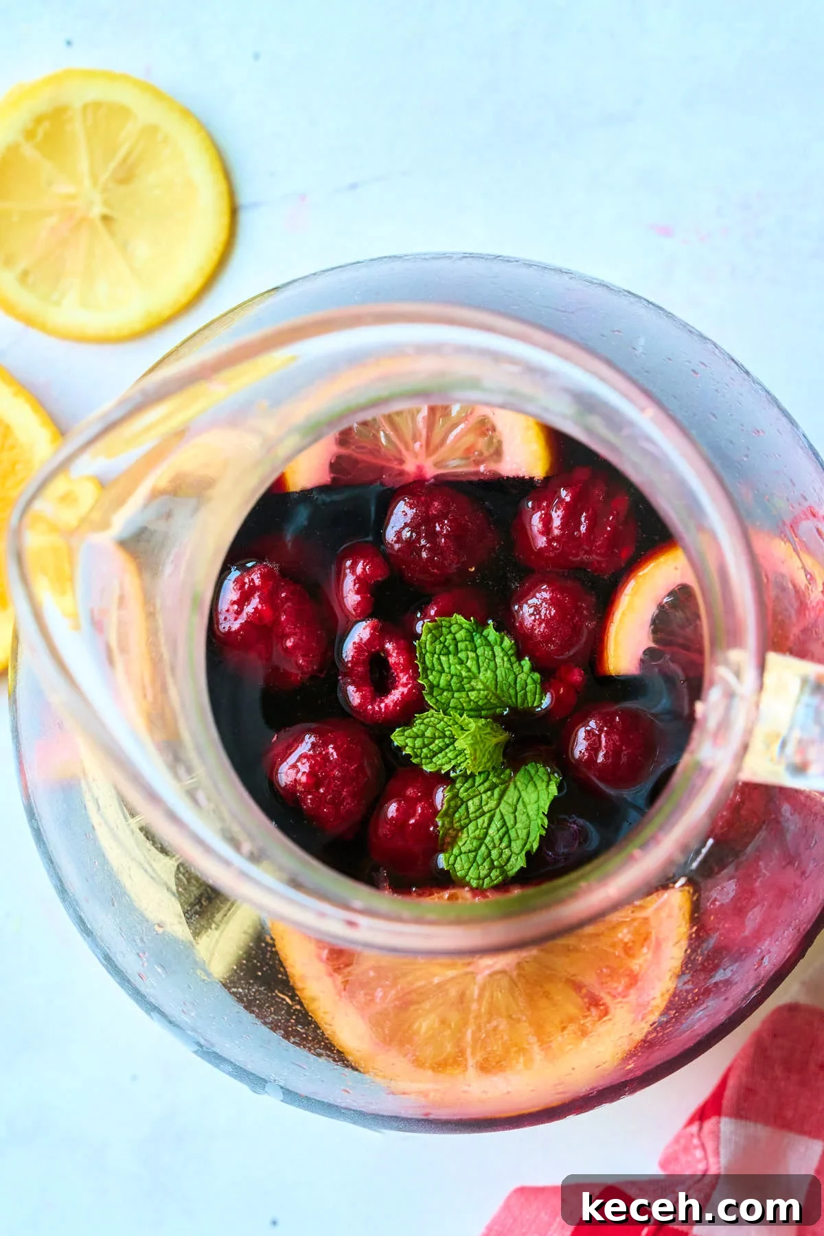 Triple Berry Sangria Recipe: Refreshing Summer Wine Punch 2 overhead view of pitcher with mint and berries.