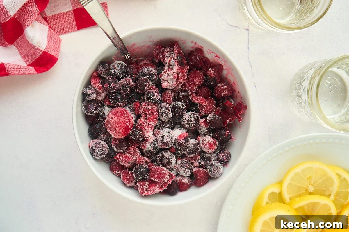Triple Berry Sangria Recipe: Refreshing Summer Wine Punch 3 bowl of fruit mixed with sugar.