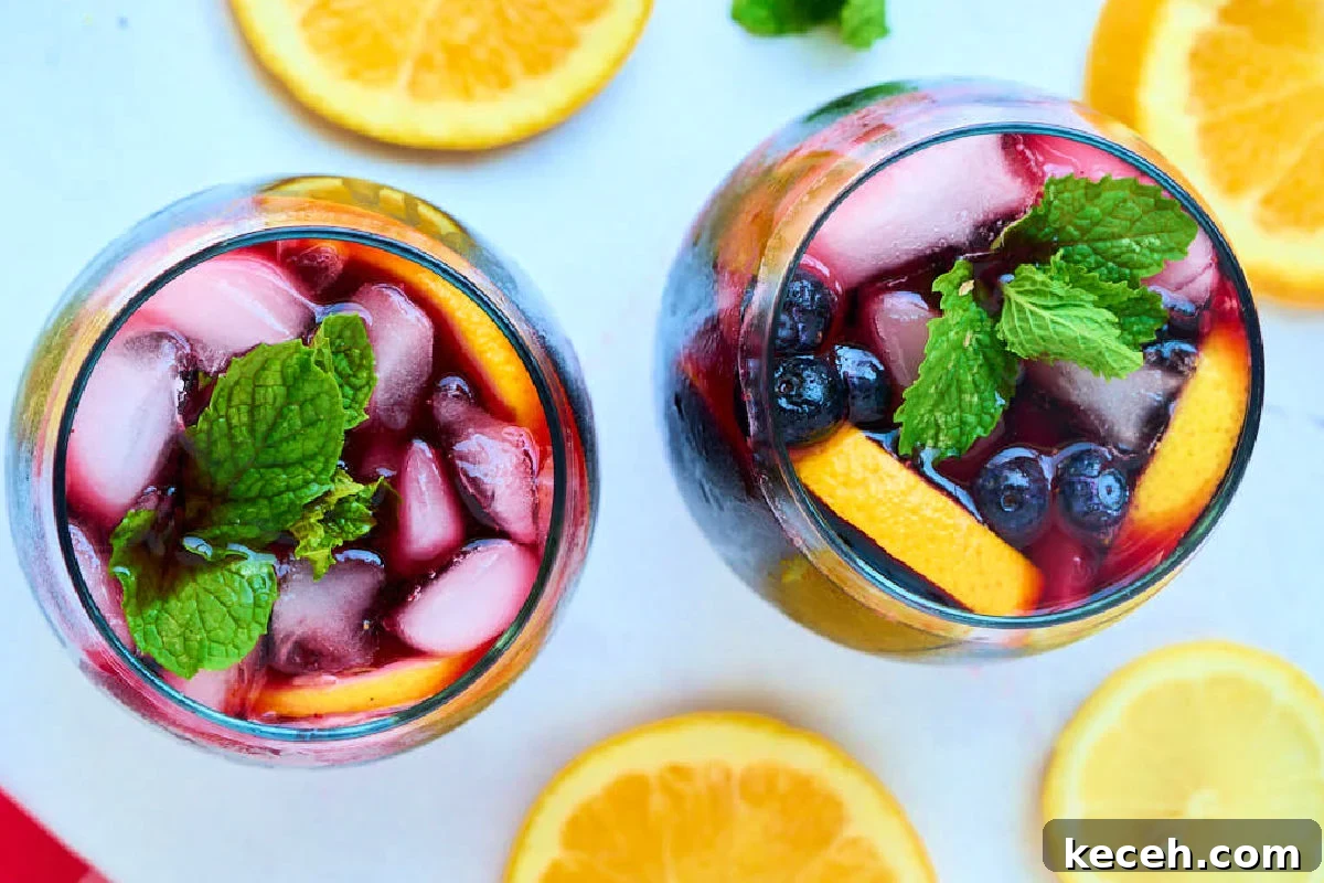 Triple Berry Sangria Recipe: Refreshing Summer Wine Punch 5 glasses of sangria with berries.