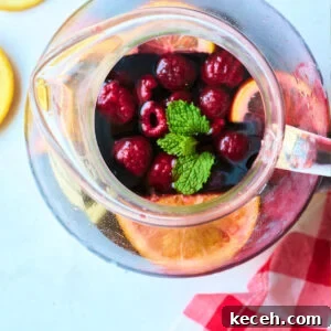 Triple Berry Sangria Recipe: Refreshing Summer Wine Punch 6 overhead view of pitcher with mint and berries.