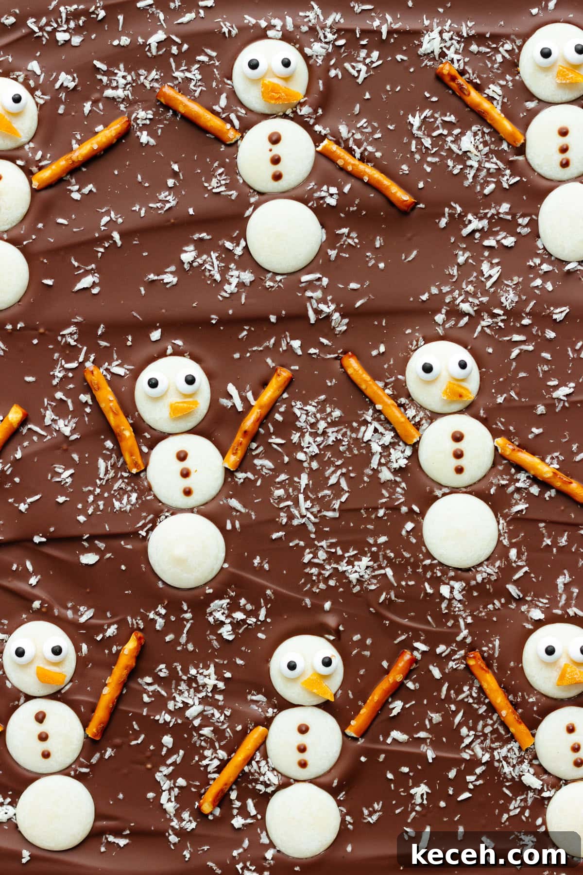 Snowman Chocolate Bark Recipe for Christmas Treats 2 Christmas bark with white chocolate snowmen on top.