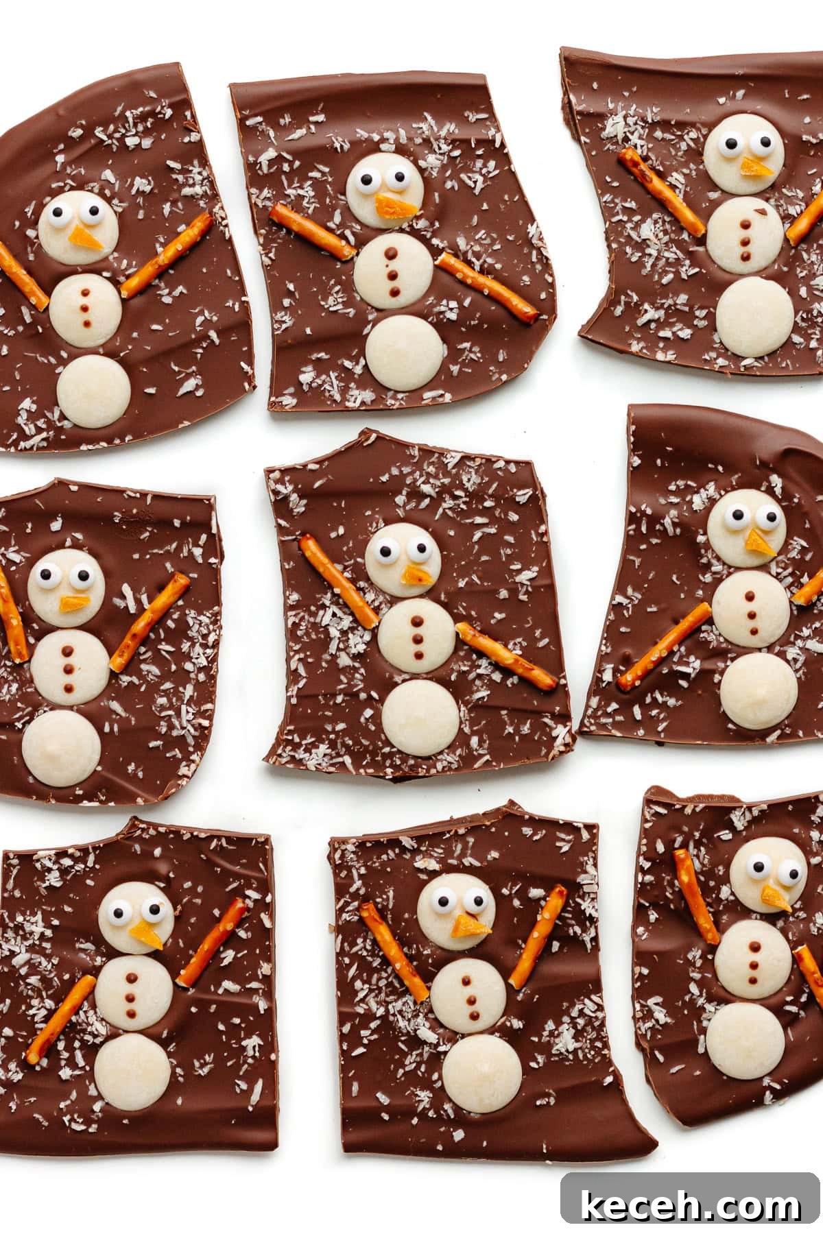 Snowman Chocolate Bark Recipe for Christmas Treats 11 Snowman chocolate bark cut into pieces on a white background.