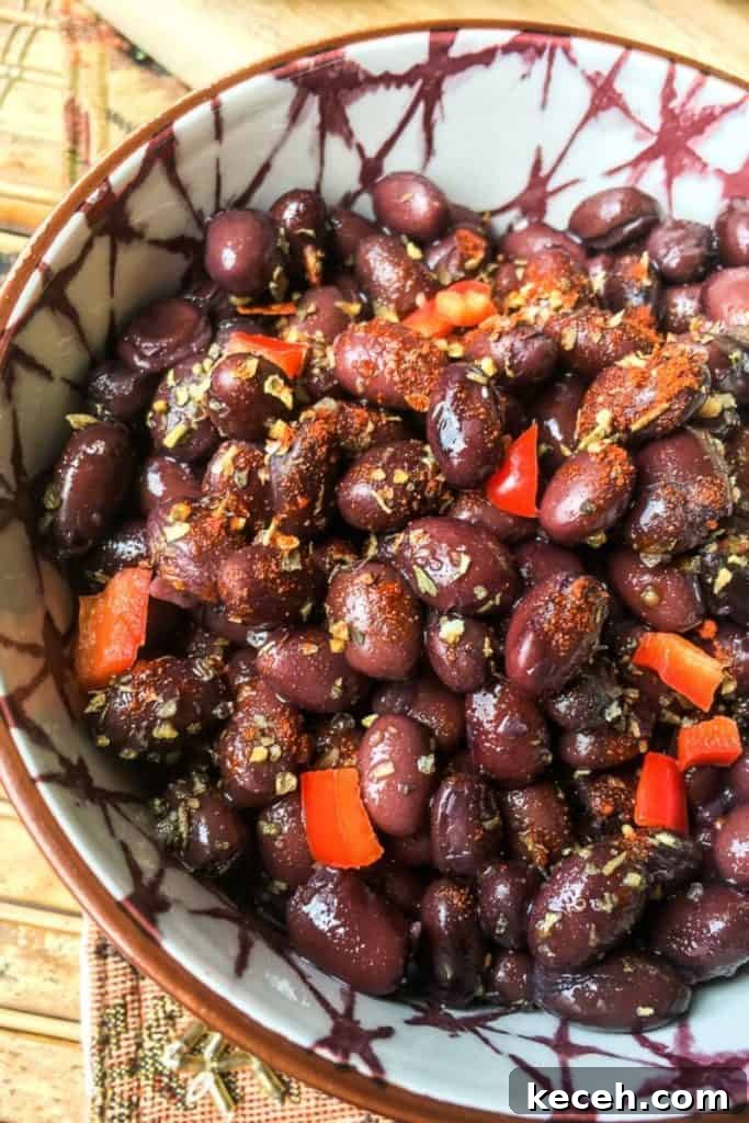 Black Bean Tacos with Fresh Homemade Guacamole Recipe 4 Black beans in a bowl with red peppers.