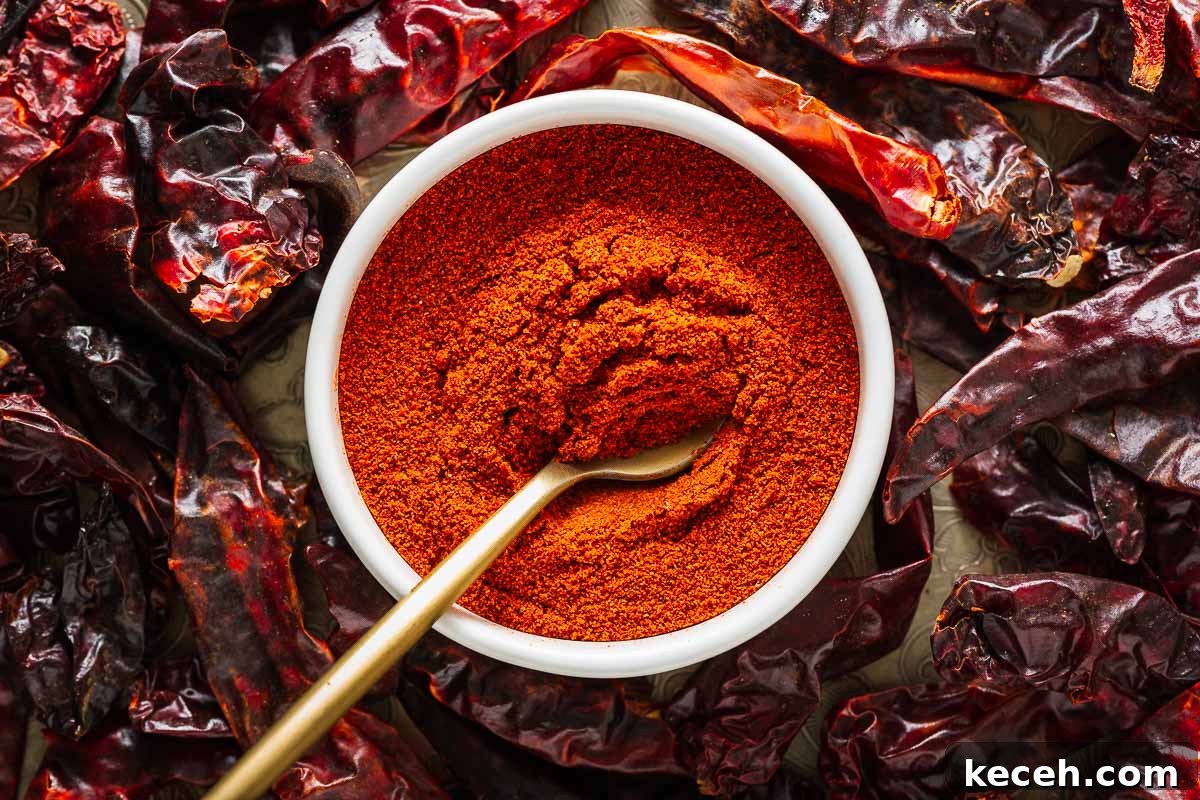 Top Substitutes for Aleppo Pepper: Flavorful Alternatives You Can Use 11 Ground cayenne pepper in a small white bowl with a golden spoon surrounded by dried chillies viewed from above.