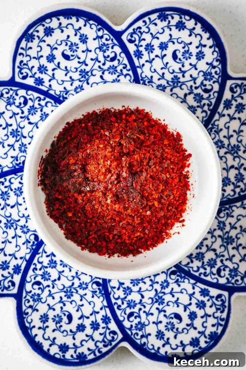 Top Substitutes for Aleppo Pepper: Flavorful Alternatives You Can Use 5 A small white bowl with chilli flakes and sunflower oil viewed from above.
