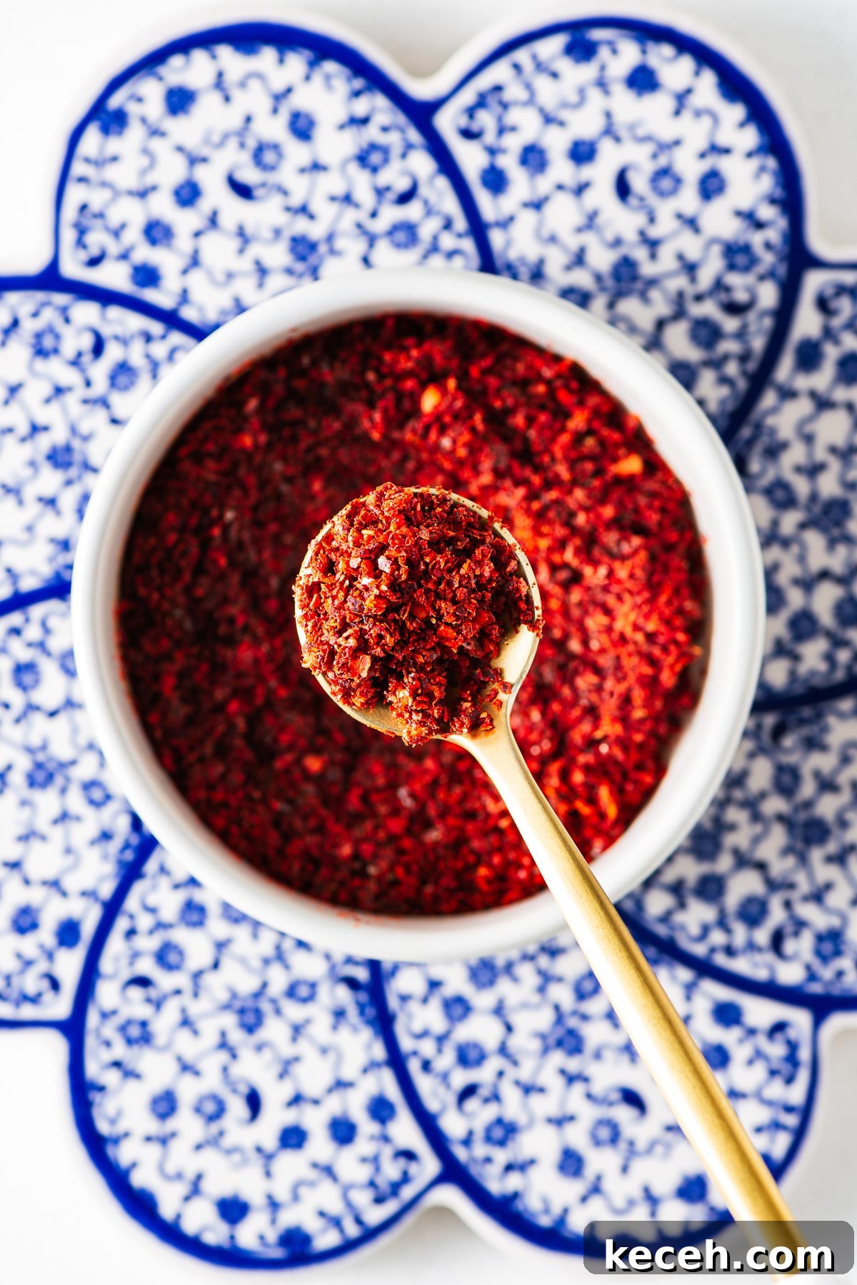 Top Substitutes for Aleppo Pepper: Flavorful Alternatives You Can Use 7 Homemade Aleppo-style pepper substitute in a small white bowl with a golden teaspoon.