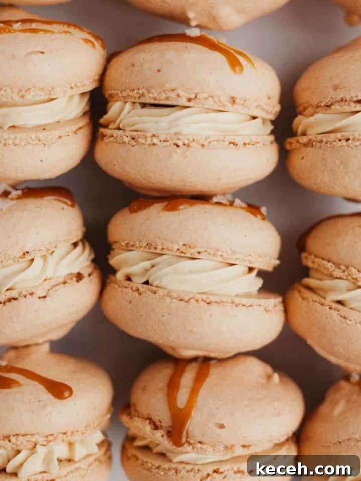 Salted caramel macarons drizzled with caramel and flaky salt