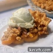 Perfect Peach Crumble Pie Recipe for Summer Baking 3 A slice of peach pie with a crumble topping on a plate.